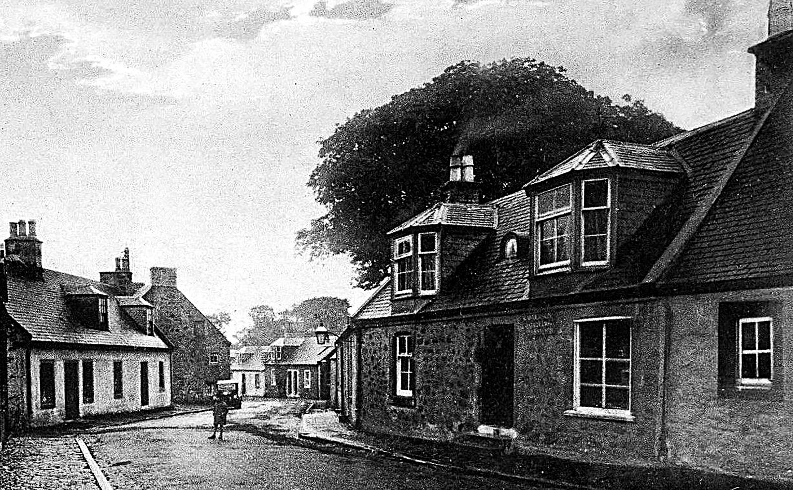 A historic photograph of the village street in Symington, showing the inn as a long-standing hostelry.